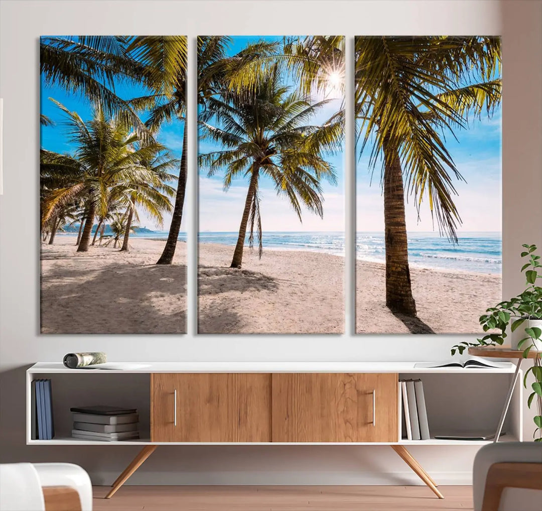 A living room showcasing the Palm Beach Tropical Island Wall Art Canvas Print, a triptych of palm trees on a sandy beach, offered in museum-quality canvas.