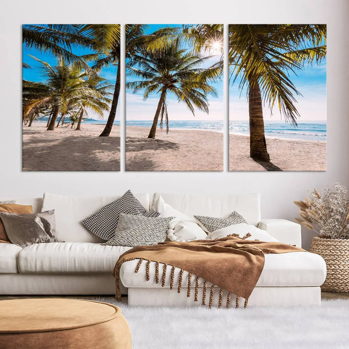 A living room showcasing the Palm Beach Tropical Island Wall Art Canvas Print, a triptych of palm trees on a sandy beach, offered in museum-quality canvas.