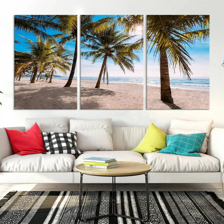 A living room showcasing the Palm Beach Tropical Island Wall Art Canvas Print, a triptych of palm trees on a sandy beach, offered in museum-quality canvas.