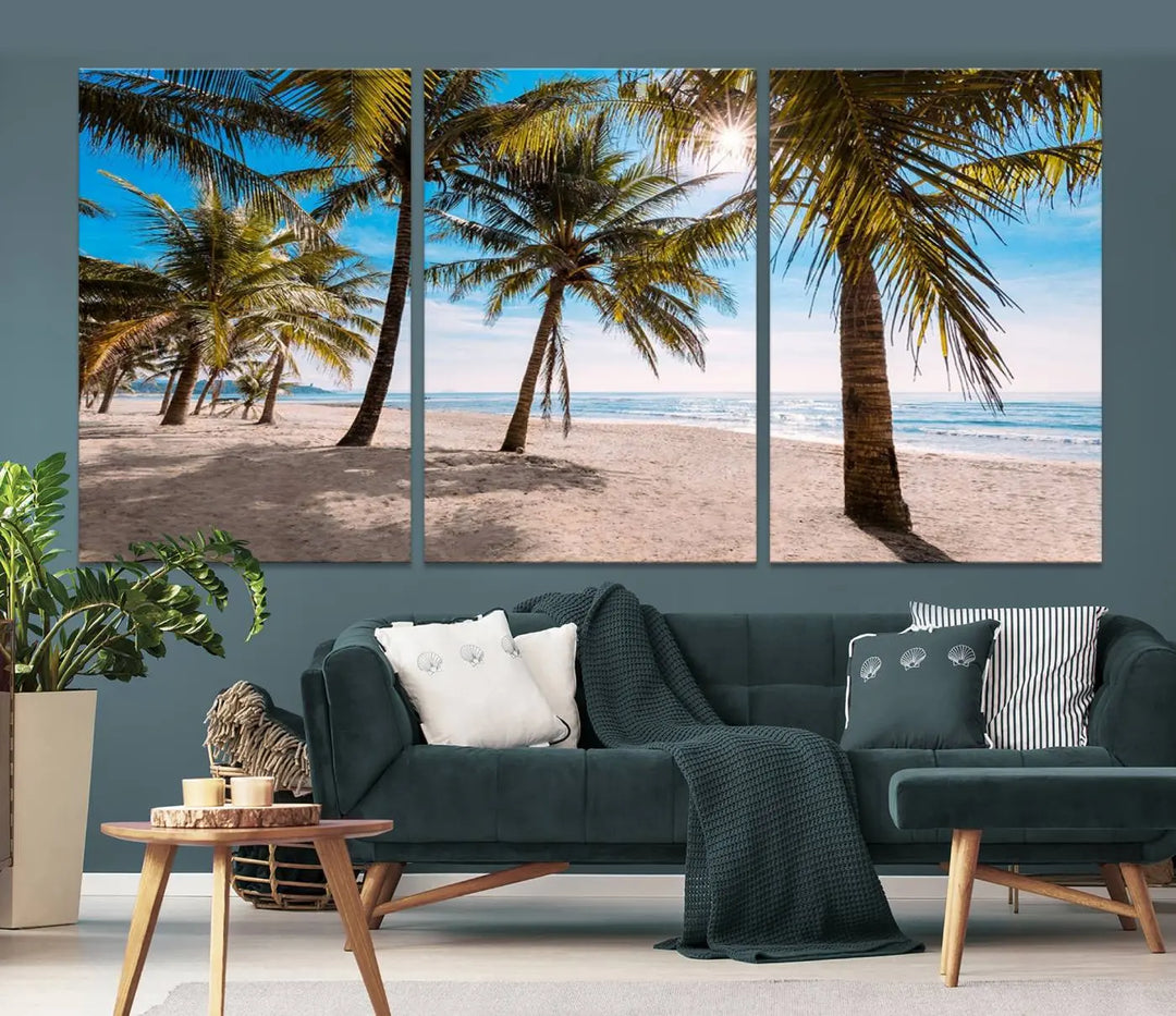 A living room showcasing the Palm Beach Tropical Island Wall Art Canvas Print, a triptych of palm trees on a sandy beach, offered in museum-quality canvas.