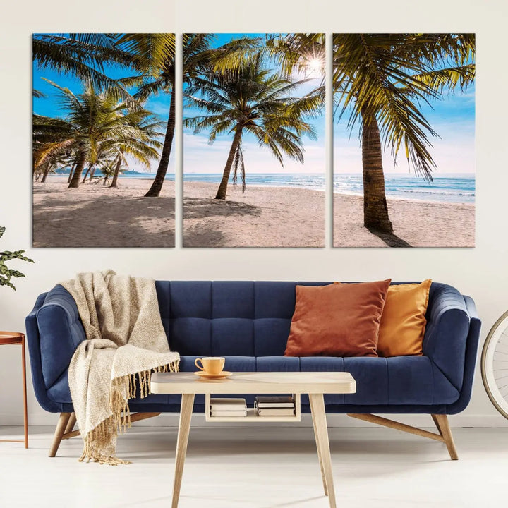 A living room showcasing the Palm Beach Tropical Island Wall Art Canvas Print, a triptych of palm trees on a sandy beach, offered in museum-quality canvas.