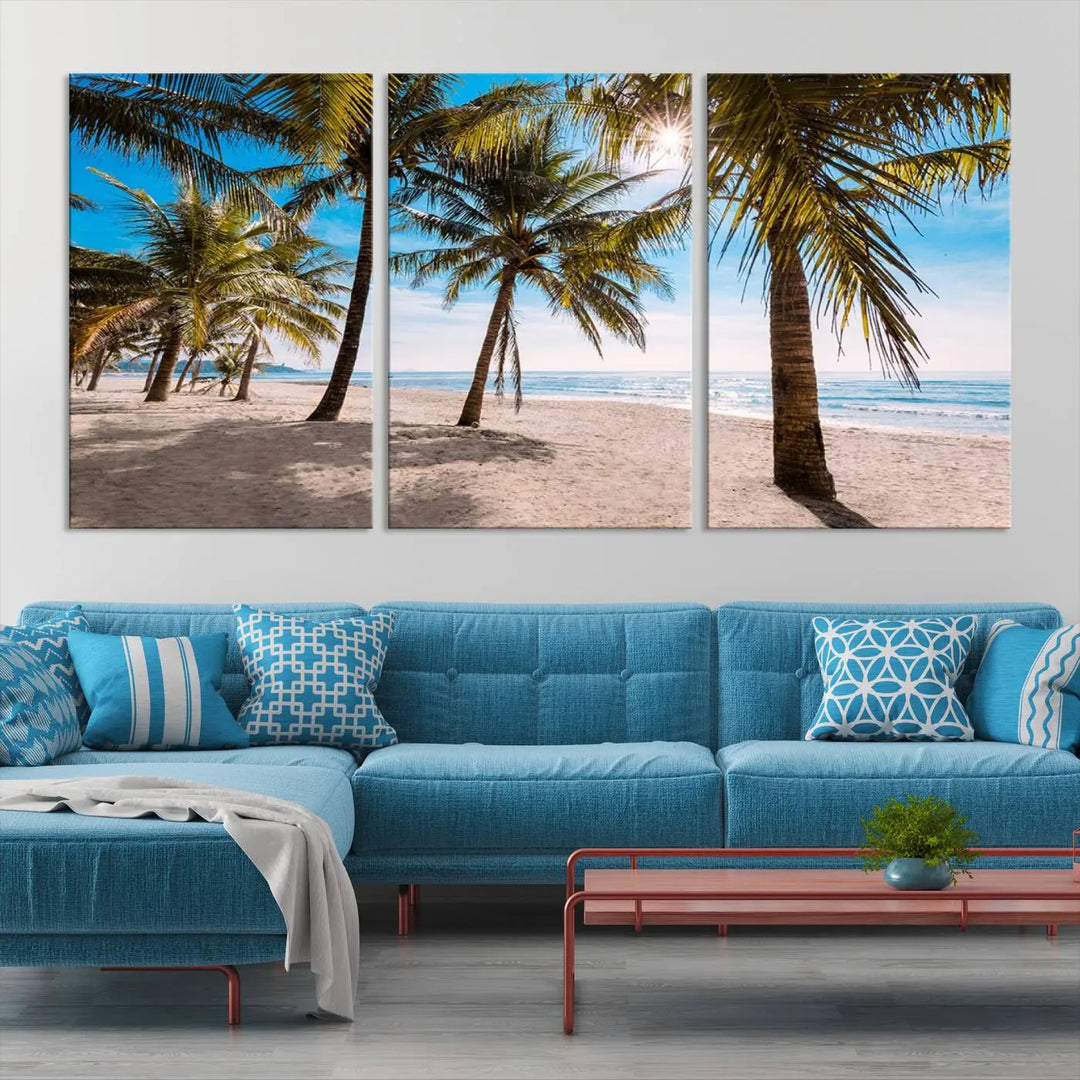 A living room showcasing the Palm Beach Tropical Island Wall Art Canvas Print, a triptych of palm trees on a sandy beach, offered in museum-quality canvas.