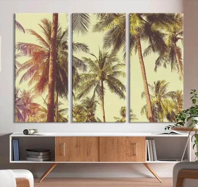 The living room features the Palm Tree Wall Art Tropical Coast Canvas Print, displayed as a triptych on museum-quality canvas. Each piece is gallery wrapped for a polished look.