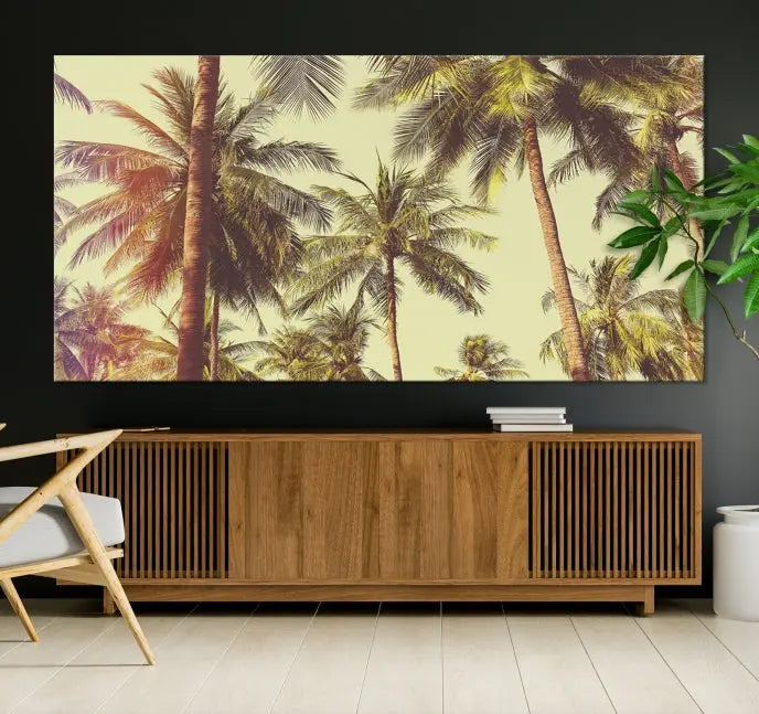 The living room features the Palm Tree Wall Art Tropical Coast Canvas Print, displayed as a triptych on museum-quality canvas. Each piece is gallery wrapped for a polished look.