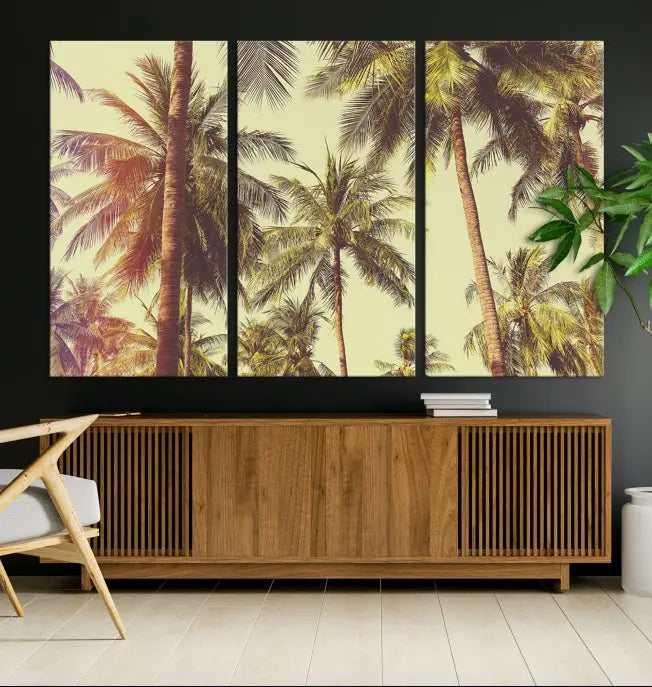 The living room features the Palm Tree Wall Art Tropical Coast Canvas Print, displayed as a triptych on museum-quality canvas. Each piece is gallery wrapped for a polished look.