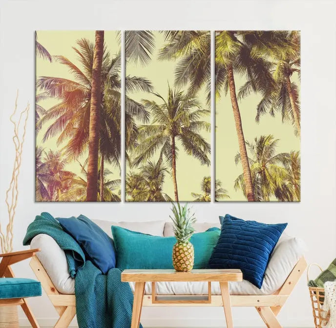 The living room features the Palm Tree Wall Art Tropical Coast Canvas Print, displayed as a triptych on museum-quality canvas. Each piece is gallery wrapped for a polished look.