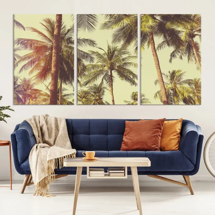 The living room features the Palm Tree Wall Art Tropical Coast Canvas Print, displayed as a triptych on museum-quality canvas. Each piece is gallery wrapped for a polished look.