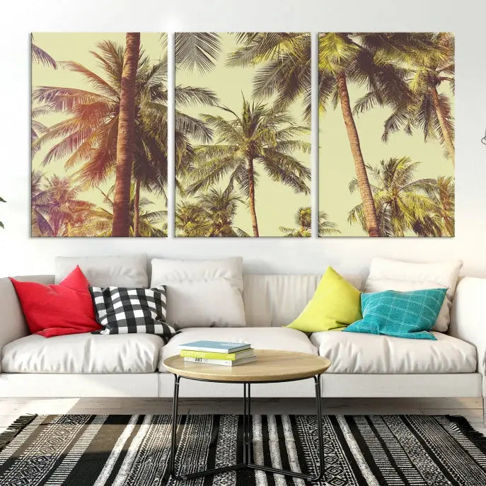 The living room features the Palm Tree Wall Art Tropical Coast Canvas Print, displayed as a triptych on museum-quality canvas. Each piece is gallery wrapped for a polished look.