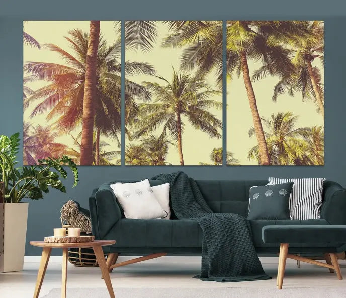 The living room features the Palm Tree Wall Art Tropical Coast Canvas Print, displayed as a triptych on museum-quality canvas. Each piece is gallery wrapped for a polished look.