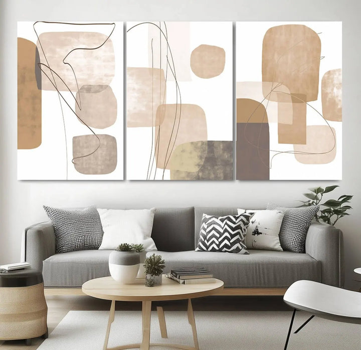 Pastel Boho Wall Art Canvas Print Set Mid-Century Prints featuring abstract art with beige and brown shapes adorns a dark wall, gallery wrapped for a sleek look.