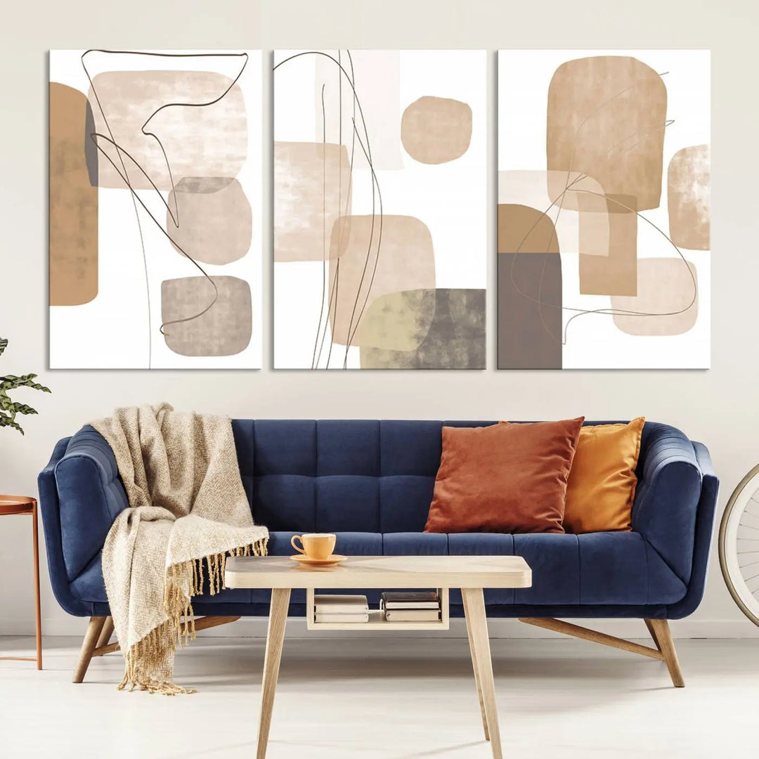 Pastel Boho Wall Art Canvas Print Set Mid-Century Prints featuring abstract art with beige and brown shapes adorns a dark wall, gallery wrapped for a sleek look.