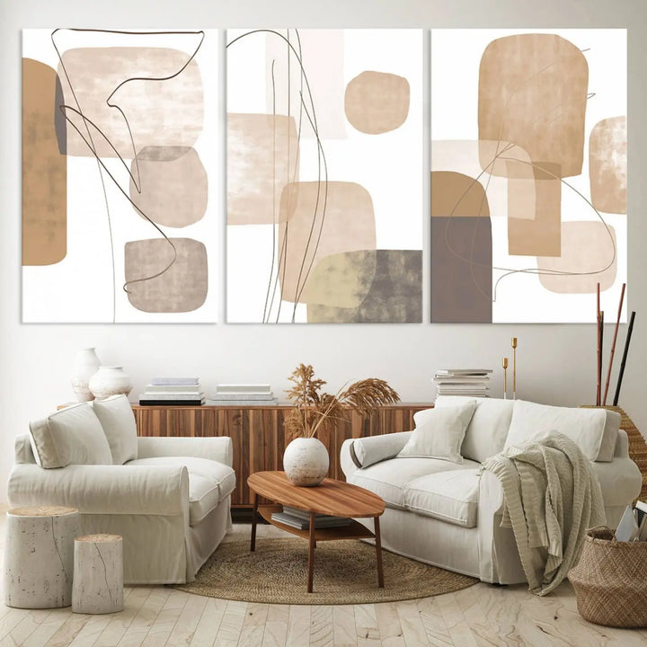 Pastel Boho Wall Art Canvas Print Set Mid-Century Prints featuring abstract art with beige and brown shapes adorns a dark wall, gallery wrapped for a sleek look.