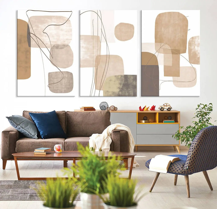 Pastel Boho Wall Art Canvas Print Set Mid-Century Prints featuring abstract art with beige and brown shapes adorns a dark wall, gallery wrapped for a sleek look.