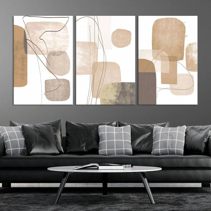 Pastel Boho Wall Art Canvas Print Set Mid-Century Prints featuring abstract art with beige and brown shapes adorns a dark wall, gallery wrapped for a sleek look.