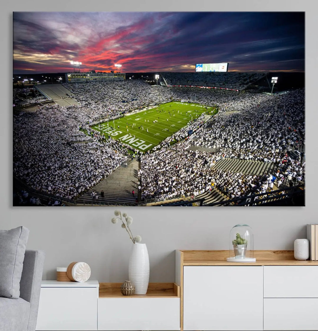 The living room features a breathtaking triptych canvas titled "Penn State Nittany Lions Football Team Print - University Park Beaver Stadium Wall Art Canvas Print," depicting a stadium at sunset. This gallery-quality finish is sure to elevate the aesthetic of any space.