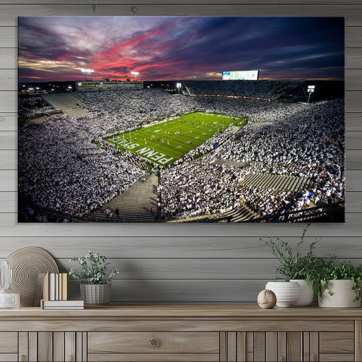 The living room features a breathtaking triptych canvas titled "Penn State Nittany Lions Football Team Print - University Park Beaver Stadium Wall Art Canvas Print," depicting a stadium at sunset. This gallery-quality finish is sure to elevate the aesthetic of any space.