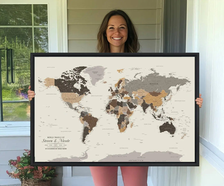 A large framed Personalized World Map Wall Art Canvas Print features custom text at the bottom, perfect for travel and exploration enthusiasts.