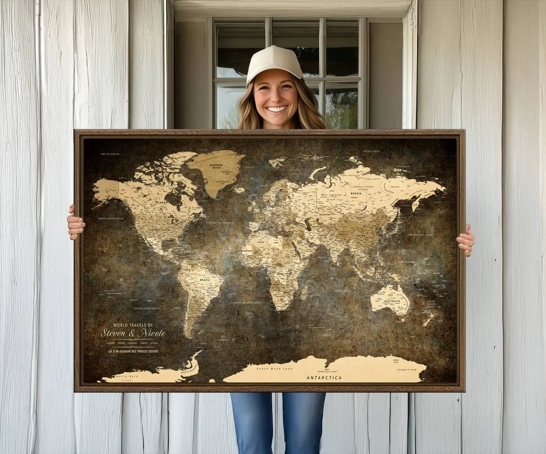 A woman beams with joy as she holds a large framed Personalized World Map Wall Art, capturing the essence of adventure and wanderlust.