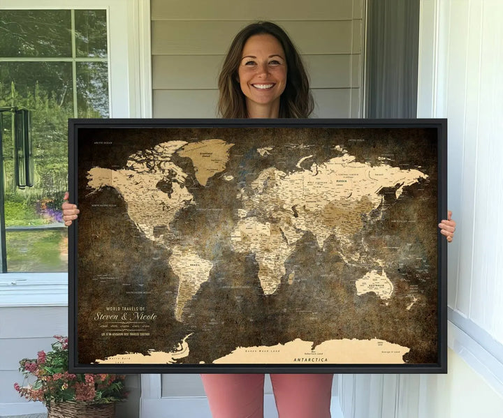 A woman beams with joy as she holds a large framed Personalized World Map Wall Art, capturing the essence of adventure and wanderlust.