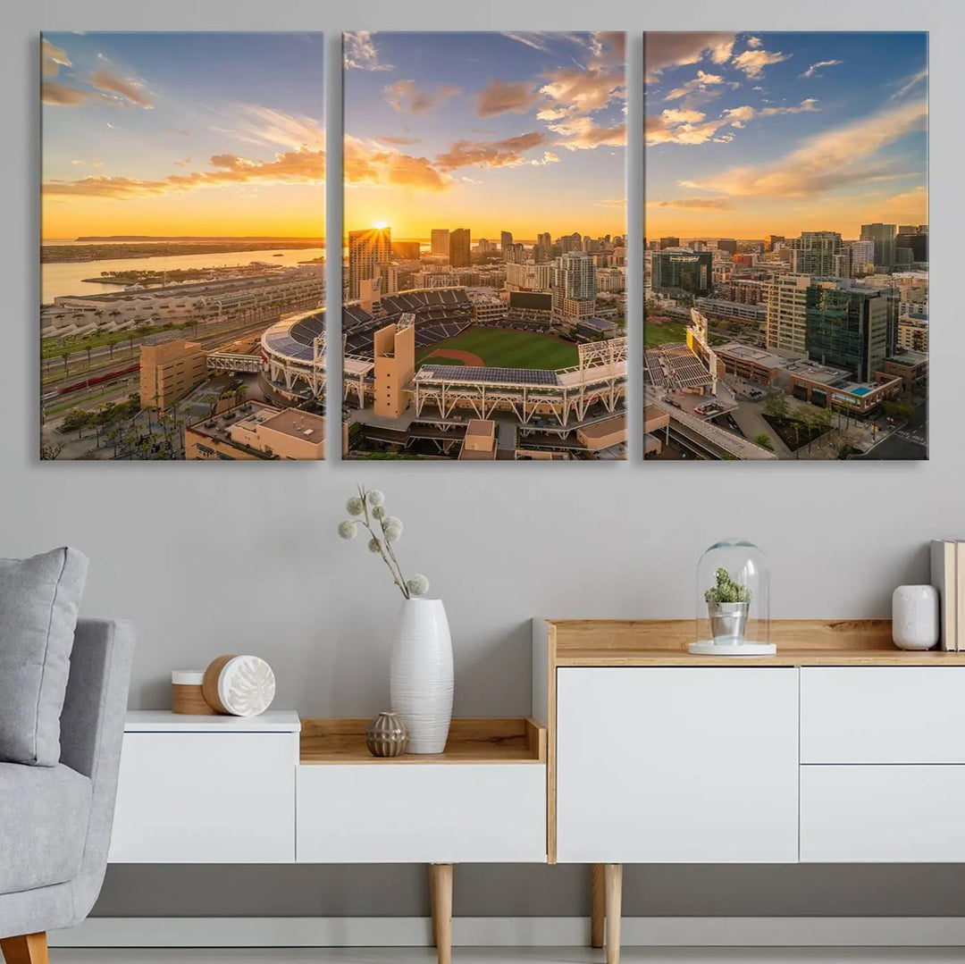 This Petco Park Sunset Triple Canvas Wall Art beautifully captures a vibrant San Diego cityscape at sunset, showcasing the iconic glow of Petco Park and high-rise buildings against a colorful sky.