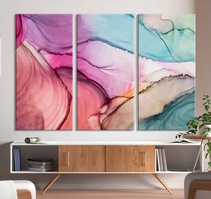 The Pink Abstract Marble Wall Art Canvas Print, a five-panel masterpiece on museum-quality canvas, showcases pink, blue, and beige waves. This gallery-wrapped artwork includes a UV-protective coating to ensure lasting vibrancy.