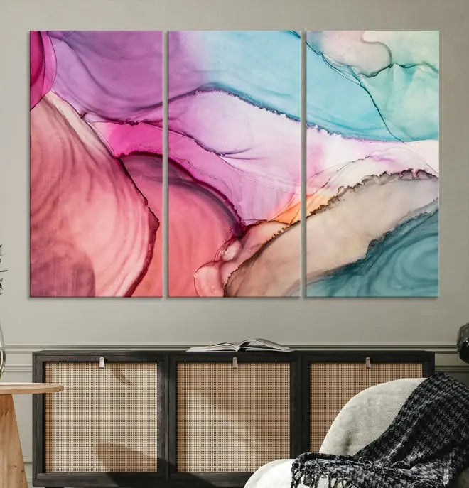 The Pink Abstract Marble Wall Art Canvas Print, a five-panel masterpiece on museum-quality canvas, showcases pink, blue, and beige waves. This gallery-wrapped artwork includes a UV-protective coating to ensure lasting vibrancy.