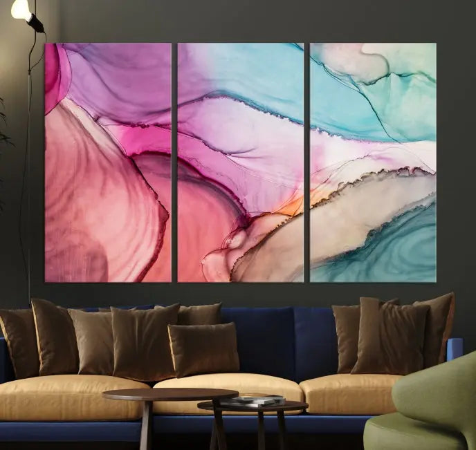 The "Pink Marble Fluid Effect Wall Art Abstract Canvas Wall Art Print" features abstract pink and blue watercolors. This piece is divided into five panels and crafted on museum-quality polycotton canvas with a UV-protective coating to ensure lasting beauty.