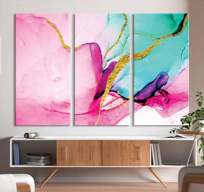 The Pink and Gold Marble Fluid Effect Wall Art Abstract Canvas Wall Art Print embellishes the space with its stunning design. Created on museum-quality canvas, this gallery-wrapped piece includes a UV-protective coating to maintain its vivid colors.