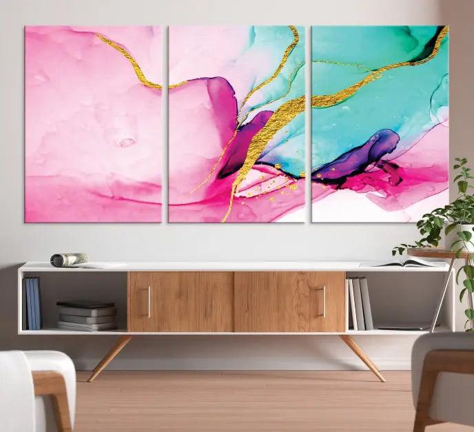 The Pink and Gold Marble Fluid Effect Wall Art Abstract Canvas Wall Art Print embellishes the space with its stunning design. Created on museum-quality canvas, this gallery-wrapped piece includes a UV-protective coating to maintain its vivid colors.