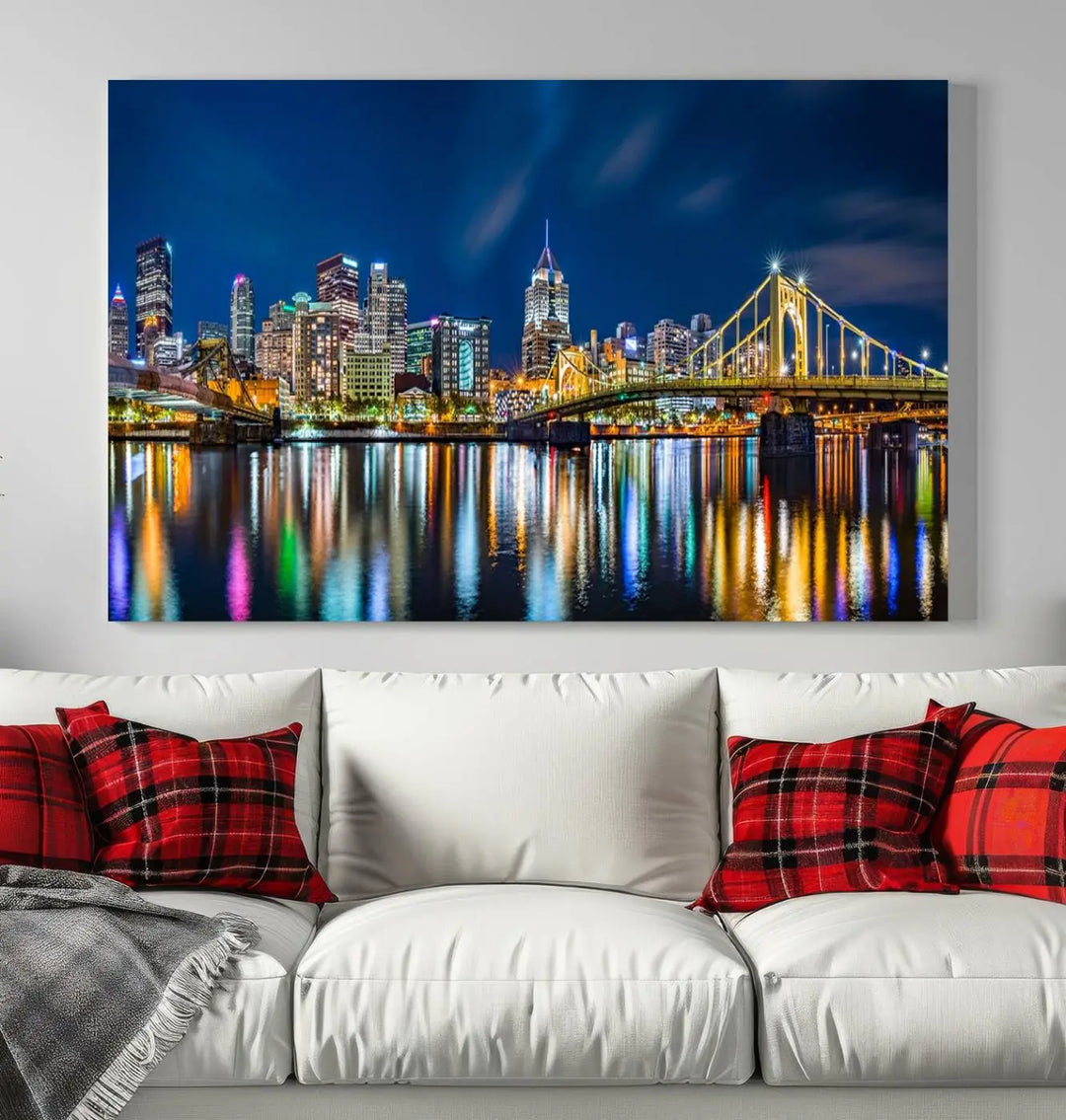 The living room features a gallery-wrapped triptych of Pittsburgh's skyline at night, reflecting on water. This Pittsburgh Skyline Canvas Wall Art is displayed above the cabinets and is printed on museum-quality canvas with a UV-protective coating to maintain its lasting vibrancy.