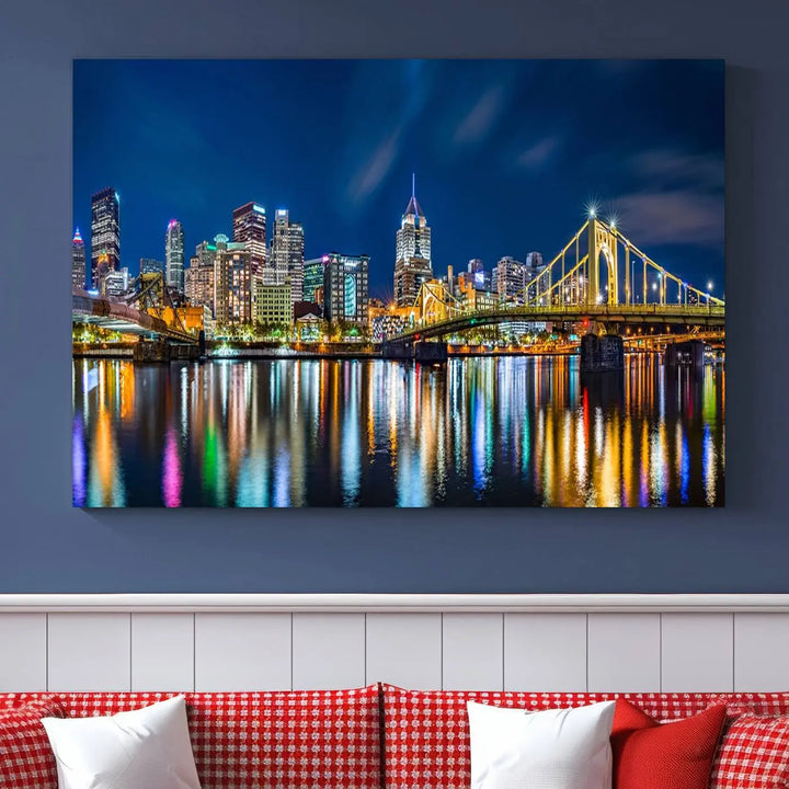 The living room features a gallery-wrapped triptych of Pittsburgh's skyline at night, reflecting on water. This Pittsburgh Skyline Canvas Wall Art is displayed above the cabinets and is printed on museum-quality canvas with a UV-protective coating to maintain its lasting vibrancy.