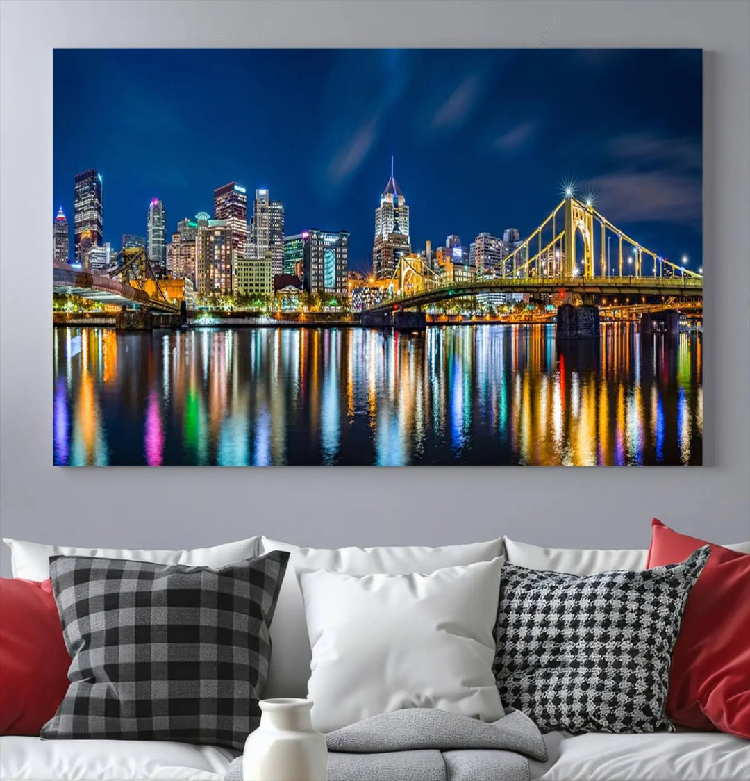 The living room features a gallery-wrapped triptych of Pittsburgh's skyline at night, reflecting on water. This Pittsburgh Skyline Canvas Wall Art is displayed above the cabinets and is printed on museum-quality canvas with a UV-protective coating to maintain its lasting vibrancy.