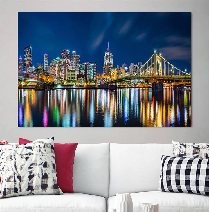 The living room features a gallery-wrapped triptych of Pittsburgh's skyline at night, reflecting on water. This Pittsburgh Skyline Canvas Wall Art is displayed above the cabinets and is printed on museum-quality canvas with a UV-protective coating to maintain its lasting vibrancy.