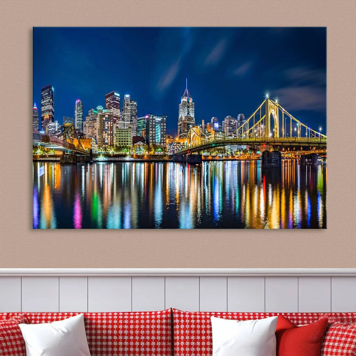 The living room features a gallery-wrapped triptych of Pittsburgh's skyline at night, reflecting on water. This Pittsburgh Skyline Canvas Wall Art is displayed above the cabinets and is printed on museum-quality canvas with a UV-protective coating to maintain its lasting vibrancy.