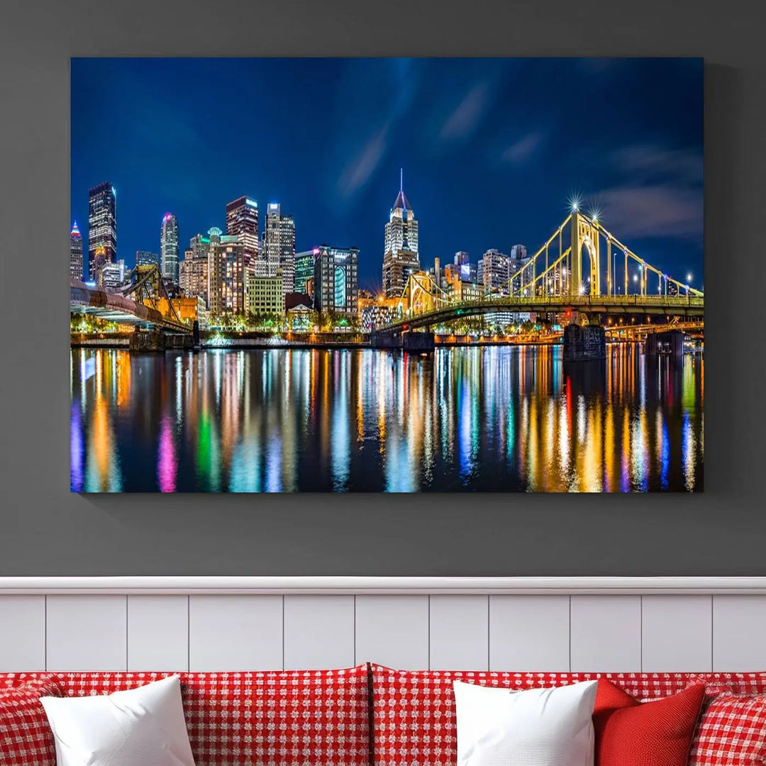 The living room features a gallery-wrapped triptych of Pittsburgh's skyline at night, reflecting on water. This Pittsburgh Skyline Canvas Wall Art is displayed above the cabinets and is printed on museum-quality canvas with a UV-protective coating to maintain its lasting vibrancy.