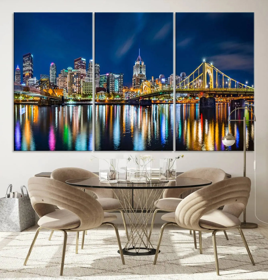 The living room features a gallery-wrapped triptych of Pittsburgh's skyline at night, reflecting on water. This Pittsburgh Skyline Canvas Wall Art is displayed above the cabinets and is printed on museum-quality canvas with a UV-protective coating to maintain its lasting vibrancy.