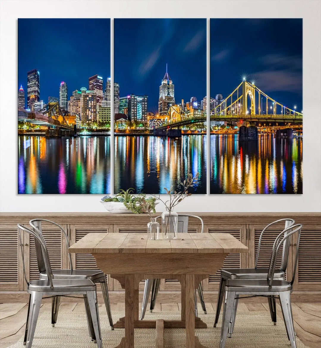 The living room features a gallery-wrapped triptych of Pittsburgh's skyline at night, reflecting on water. This Pittsburgh Skyline Canvas Wall Art is displayed above the cabinets and is printed on museum-quality canvas with a UV-protective coating to maintain its lasting vibrancy.