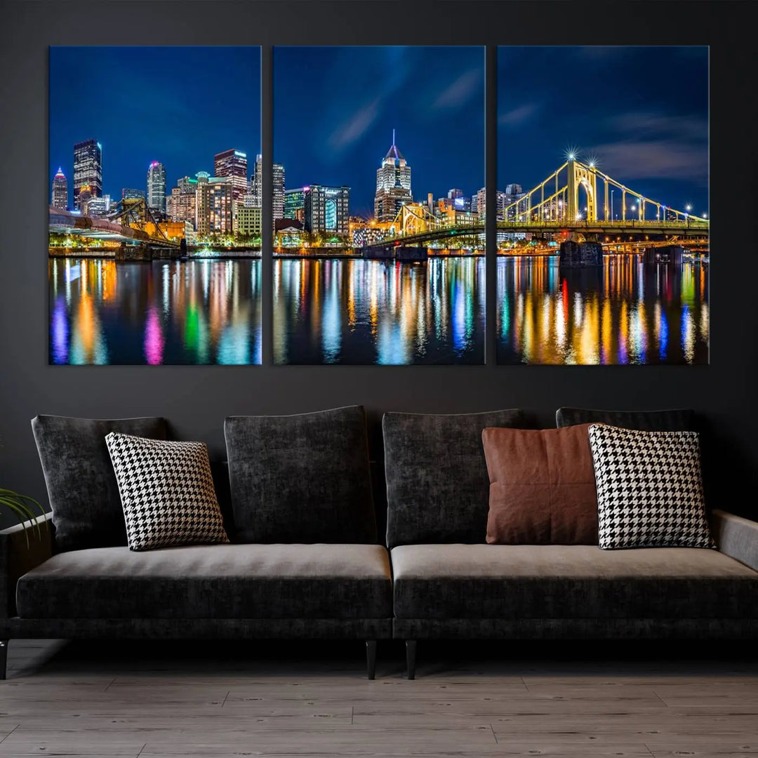 The living room features a gallery-wrapped triptych of Pittsburgh's skyline at night, reflecting on water. This Pittsburgh Skyline Canvas Wall Art is displayed above the cabinets and is printed on museum-quality canvas with a UV-protective coating to maintain its lasting vibrancy.