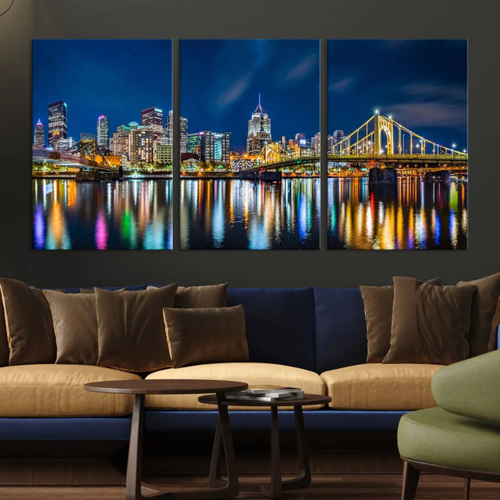 The living room features a gallery-wrapped triptych of Pittsburgh's skyline at night, reflecting on water. This Pittsburgh Skyline Canvas Wall Art is displayed above the cabinets and is printed on museum-quality canvas with a UV-protective coating to maintain its lasting vibrancy.