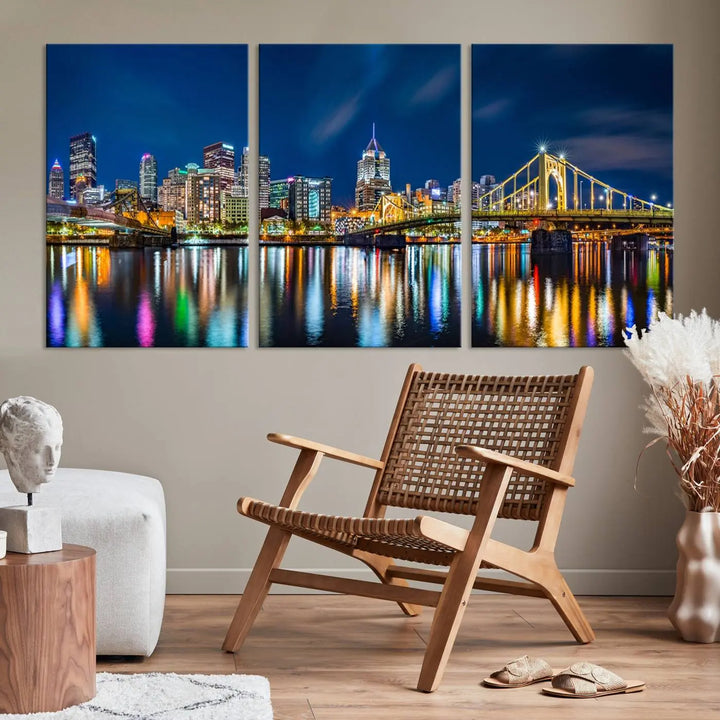 The living room features a gallery-wrapped triptych of Pittsburgh's skyline at night, reflecting on water. This Pittsburgh Skyline Canvas Wall Art is displayed above the cabinets and is printed on museum-quality canvas with a UV-protective coating to maintain its lasting vibrancy.