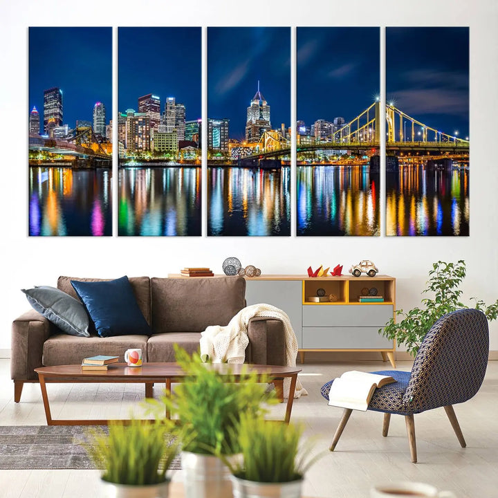 The living room features a gallery-wrapped triptych of Pittsburgh's skyline at night, reflecting on water. This Pittsburgh Skyline Canvas Wall Art is displayed above the cabinets and is printed on museum-quality canvas with a UV-protective coating to maintain its lasting vibrancy.