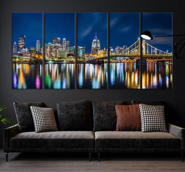 The living room features a gallery-wrapped triptych of Pittsburgh's skyline at night, reflecting on water. This Pittsburgh Skyline Canvas Wall Art is displayed above the cabinets and is printed on museum-quality canvas with a UV-protective coating to maintain its lasting vibrancy.