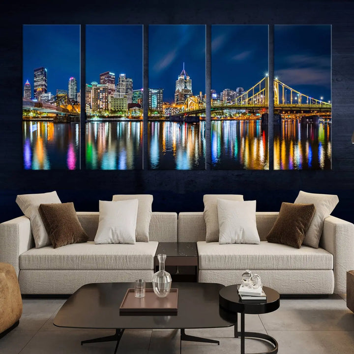 The living room features a gallery-wrapped triptych of Pittsburgh's skyline at night, reflecting on water. This Pittsburgh Skyline Canvas Wall Art is displayed above the cabinets and is printed on museum-quality canvas with a UV-protective coating to maintain its lasting vibrancy.