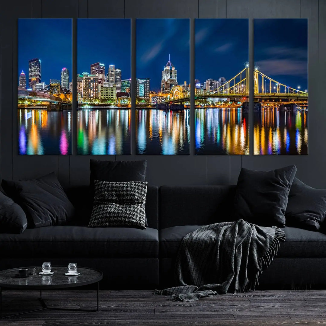 The living room features a gallery-wrapped triptych of Pittsburgh's skyline at night, reflecting on water. This Pittsburgh Skyline Canvas Wall Art is displayed above the cabinets and is printed on museum-quality canvas with a UV-protective coating to maintain its lasting vibrancy.