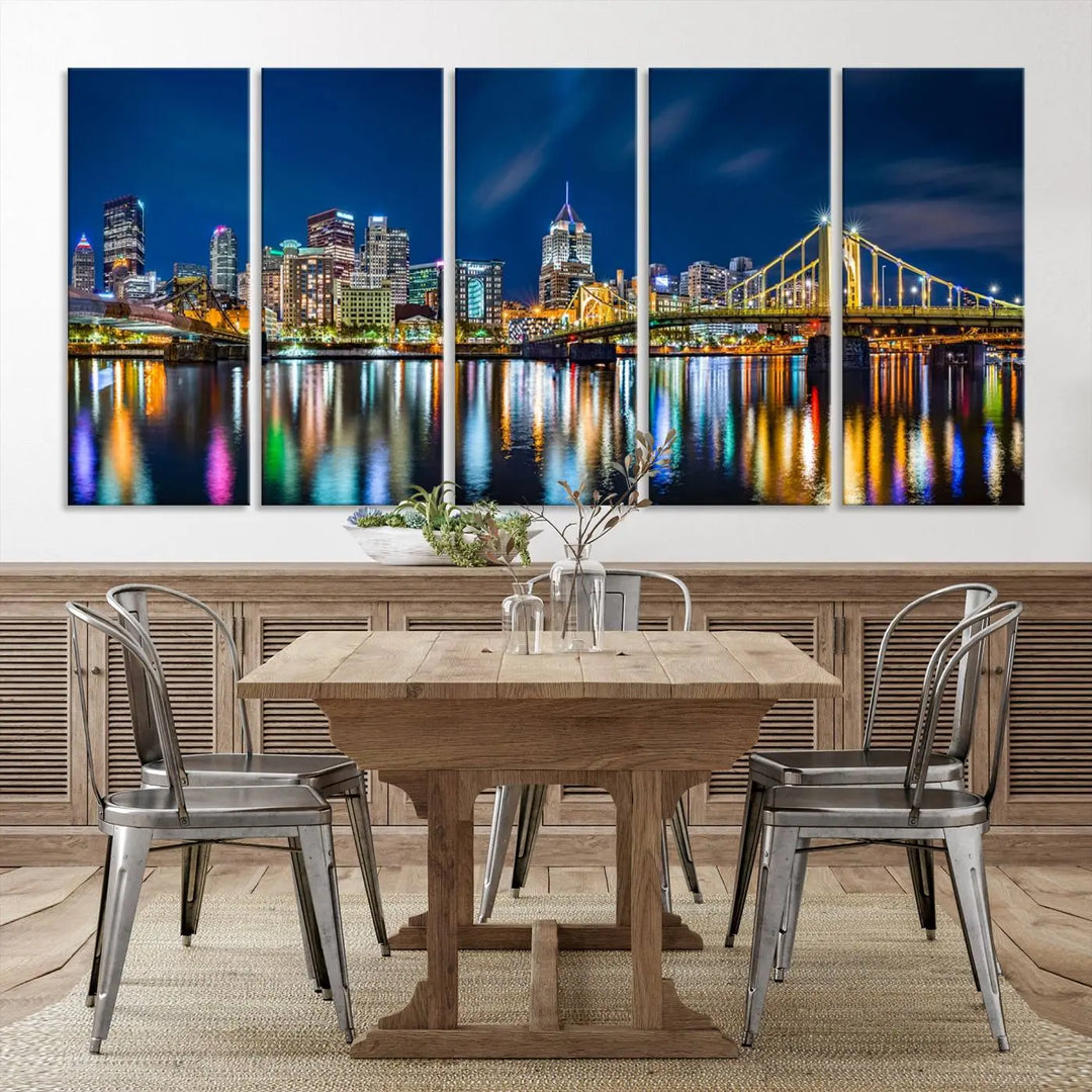 The living room features a gallery-wrapped triptych of Pittsburgh's skyline at night, reflecting on water. This Pittsburgh Skyline Canvas Wall Art is displayed above the cabinets and is printed on museum-quality canvas with a UV-protective coating to maintain its lasting vibrancy.