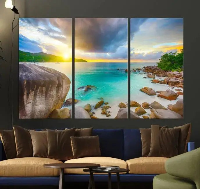 A triptych canvas of the Praslin Island Seychelles hangs on the wall. This vibrant beach sunset artwork features a UV-protective coating for lasting colors and comes with free shipping.