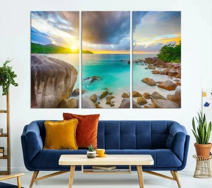 A triptych canvas of the Praslin Island Seychelles hangs on the wall. This vibrant beach sunset artwork features a UV-protective coating for lasting colors and comes with free shipping.