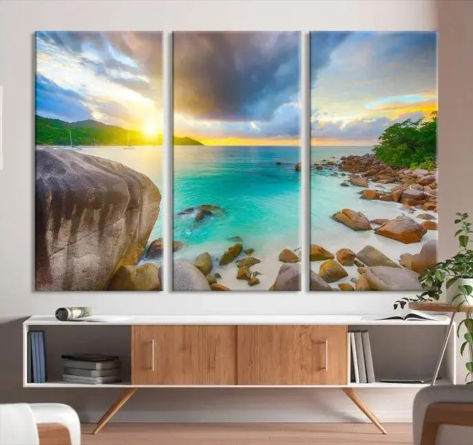 A triptych canvas of the Praslin Island Seychelles hangs on the wall. This vibrant beach sunset artwork features a UV-protective coating for lasting colors and comes with free shipping.