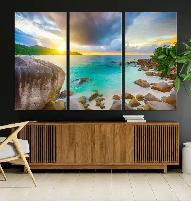 A triptych canvas of the Praslin Island Seychelles hangs on the wall. This vibrant beach sunset artwork features a UV-protective coating for lasting colors and comes with free shipping.