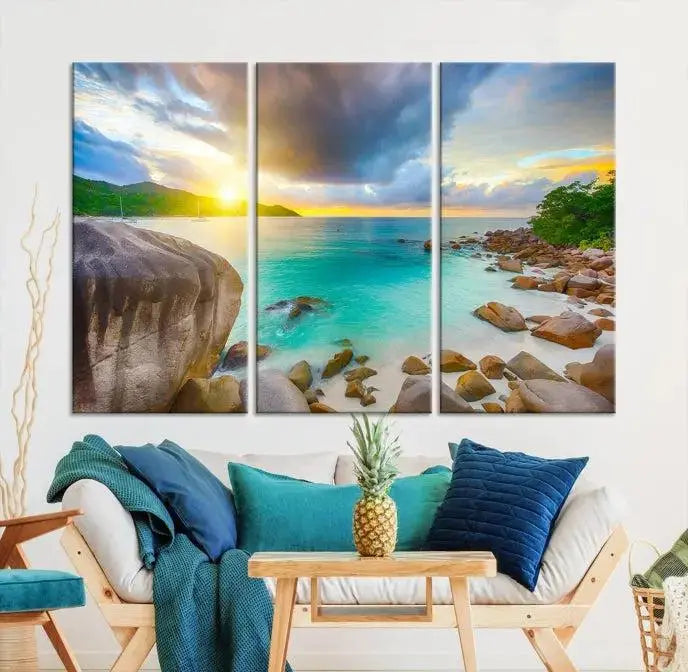 A triptych canvas of the Praslin Island Seychelles hangs on the wall. This vibrant beach sunset artwork features a UV-protective coating for lasting colors and comes with free shipping.